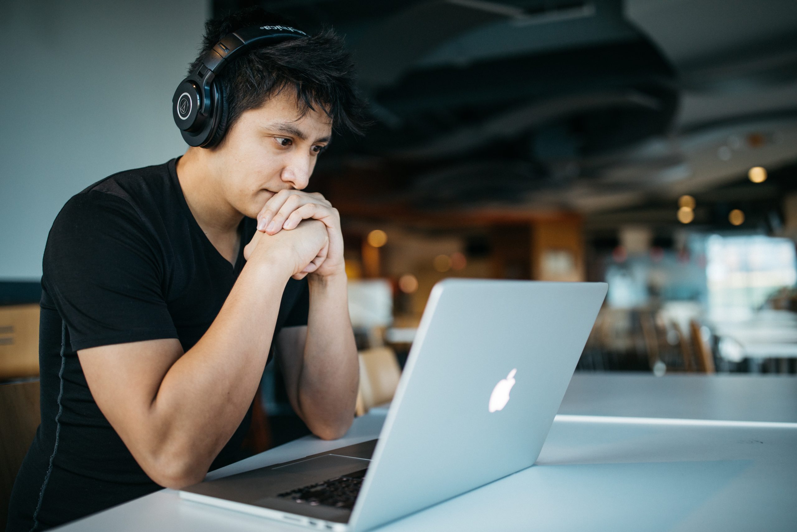 Man on laptop wearing headphones