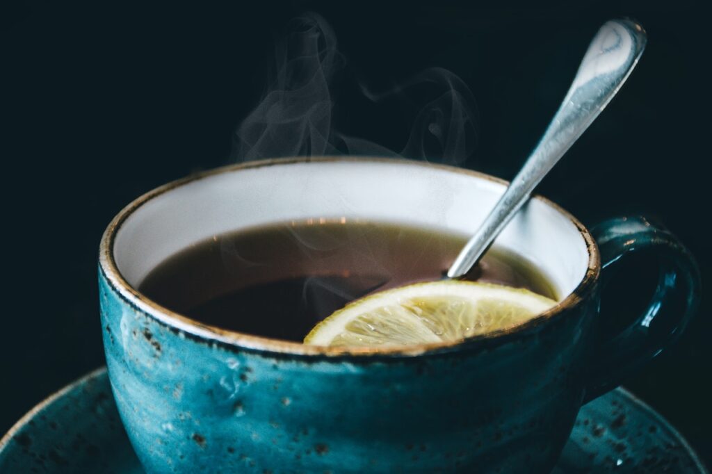 A cup of tea with a lemon slice.