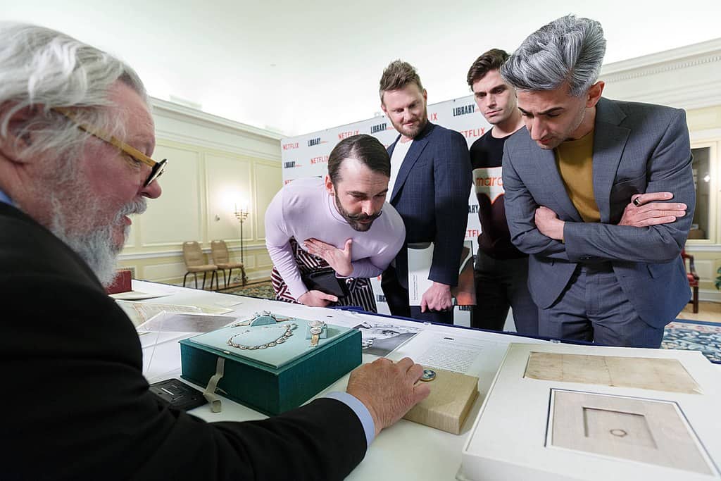 Five well-coiffed men look at a historical artifact at the Library of Congress.