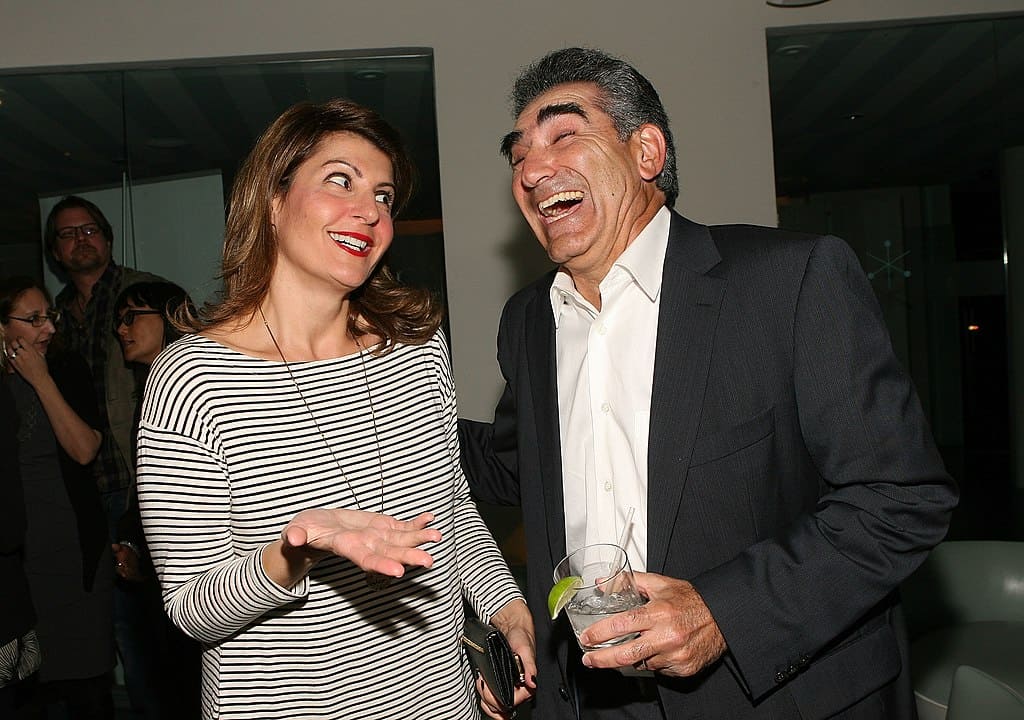 A middle-aged woman and a man laughing at a film reception (Nia Vardalos, left; Eugene Levy, right)