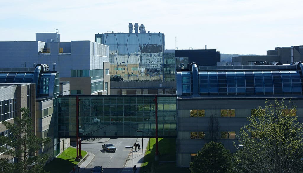 A landscape view of modern university buildings (lots of steel and glass) on the University of Waterloo campus