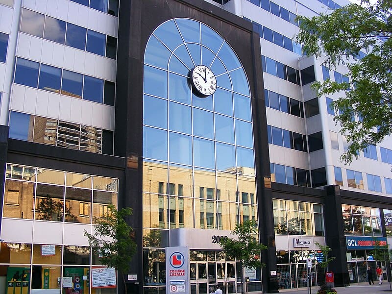 The front of a multi-storey office building, with a reflective glass 