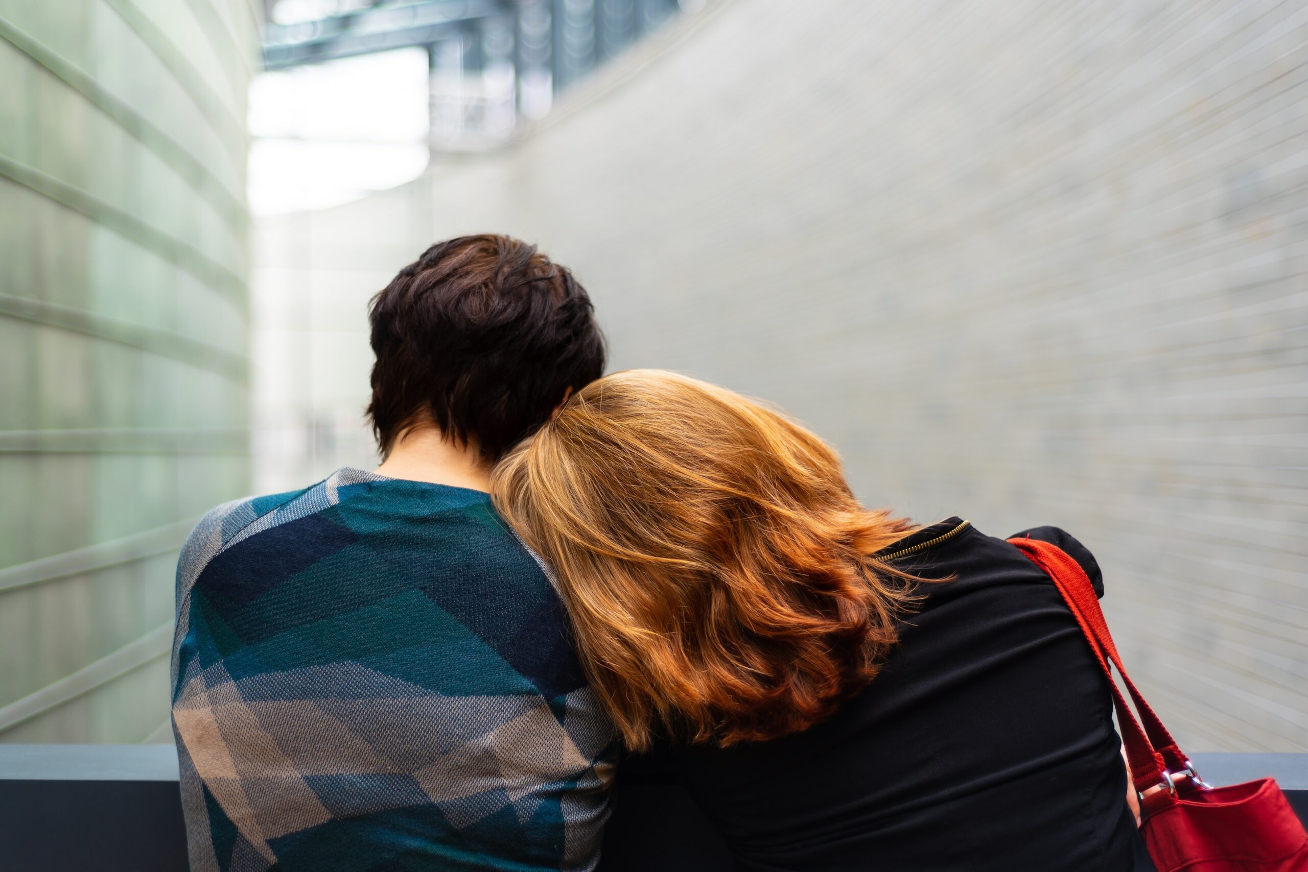 Person leaning on friend's shoulder