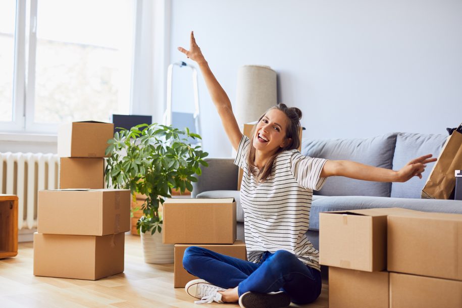 Woman sitting between moving boxes