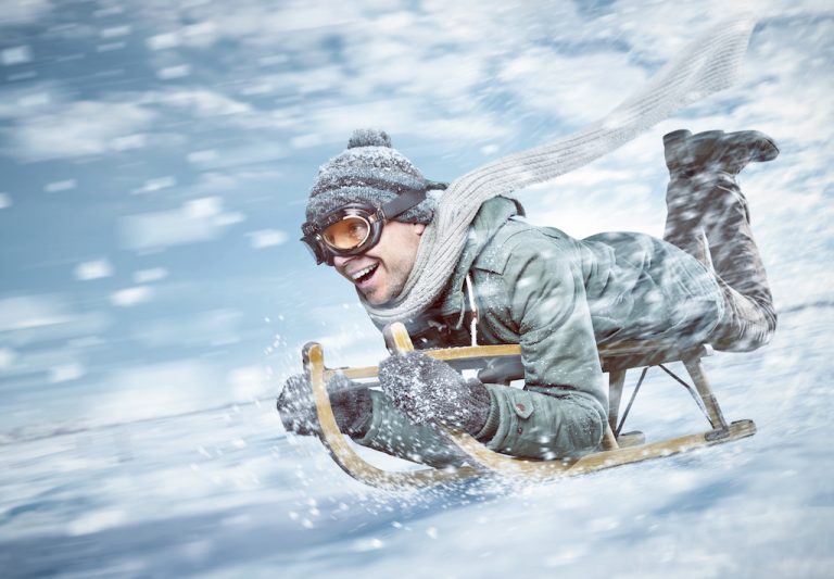 Man sledding downhill