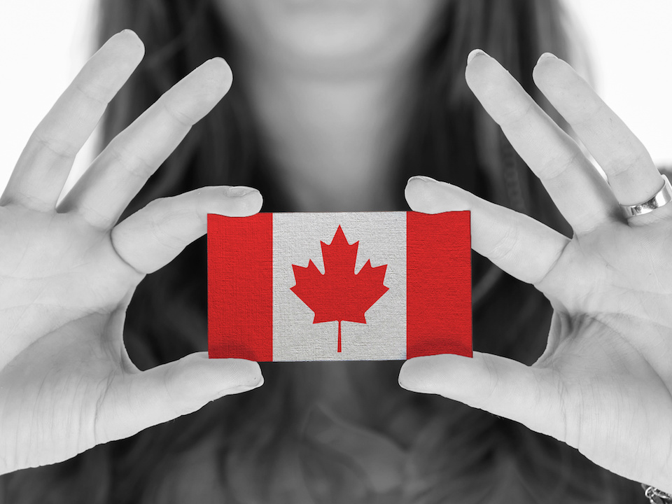 Woman holding small Canadian flag