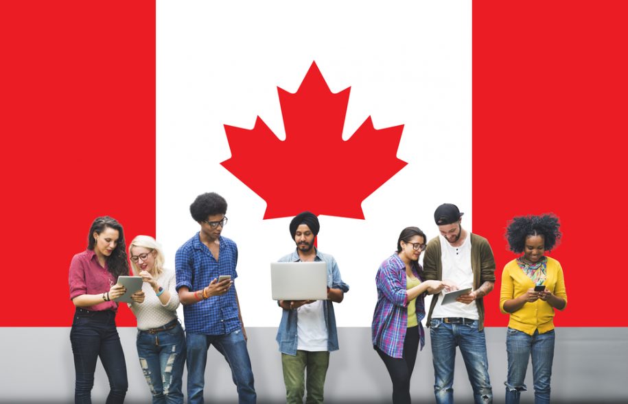 Students standing in front of Canadian flag