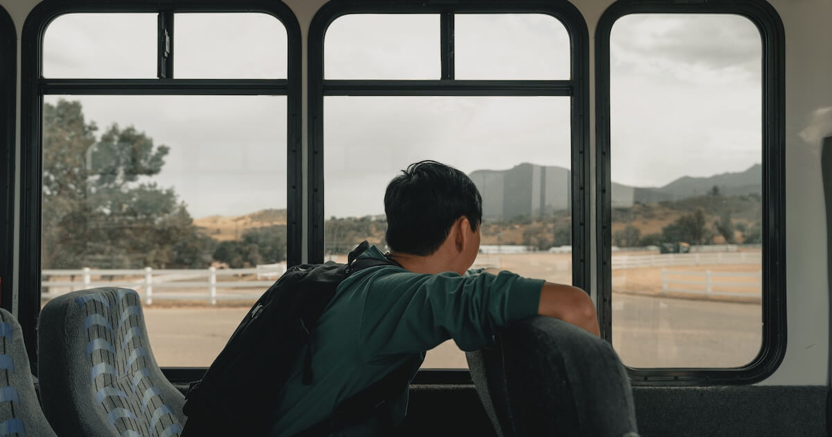 Student looking out bus window