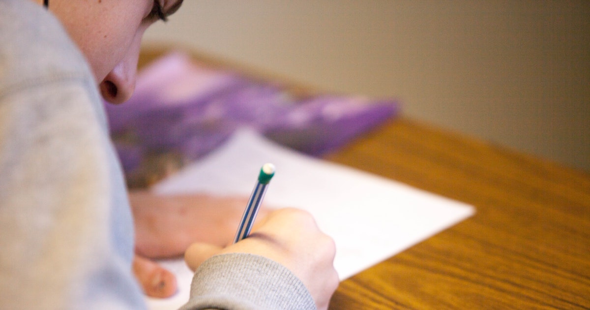 Person writing at desk
