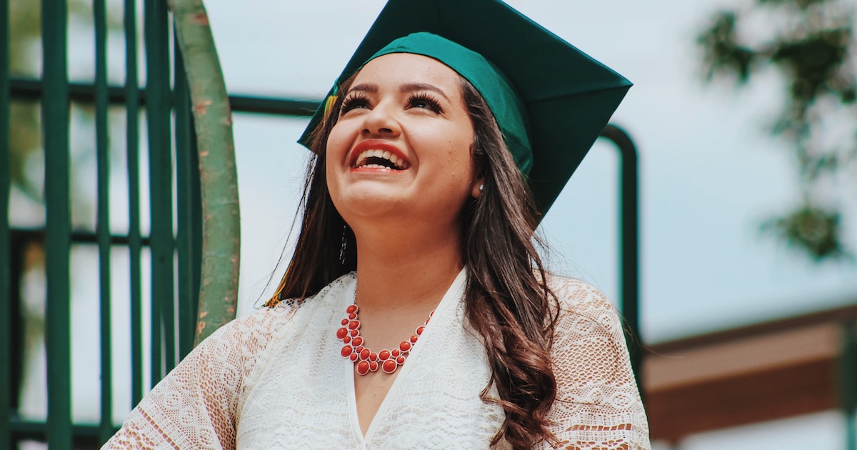Woman smiling, wearing graduation cap