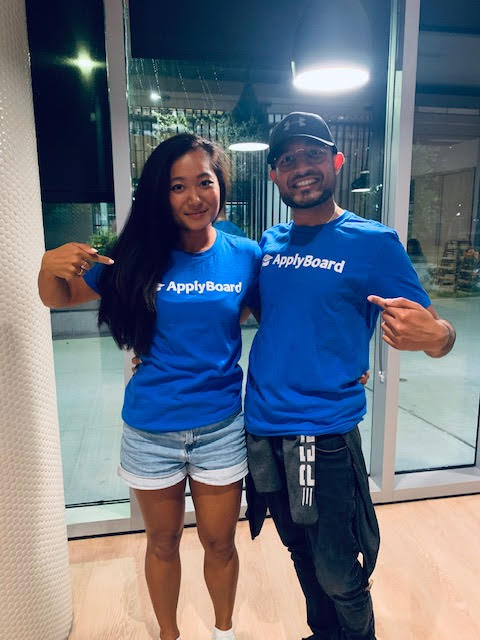 Diana and colleague show off ApplyBoard swag