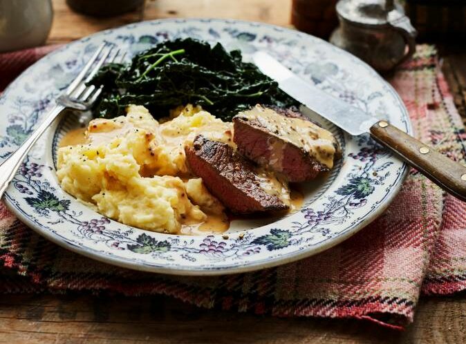 Plate of venison steaks with neeps and tatties