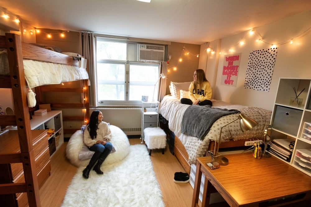 A photo of two female students hanging out in their dorm room at the University of Iowa.