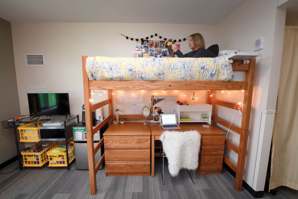 A University of Iowa student’s dorm room boasts a mini-fridge and coffee machine for her to use at her leisure.