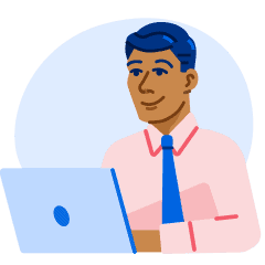 A smiling man sits behind an open laptop.