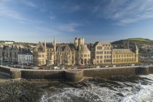 A photograph of Aberystwyth University's main campus overlooking the sea.