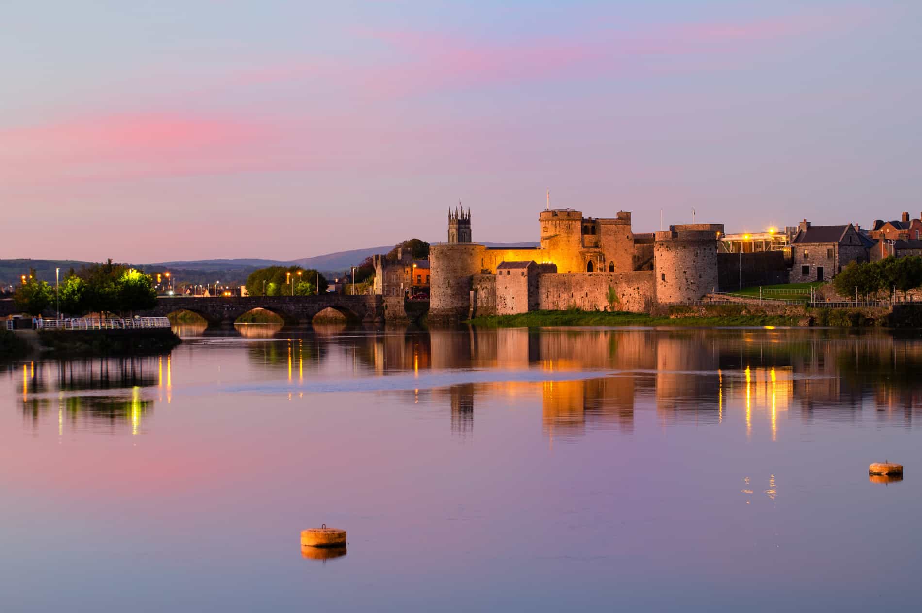 A photo of Limerick city by the water during a sunset. One of Ireland's most affordable main cities.