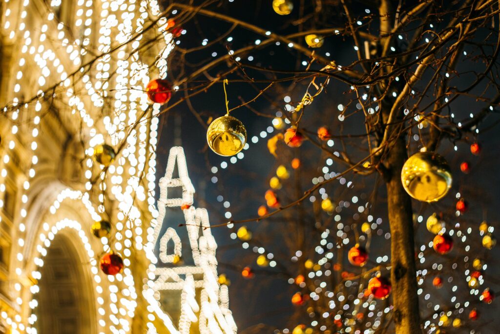 A photograph of a building with lights and a tree with ornaments in Toronto.