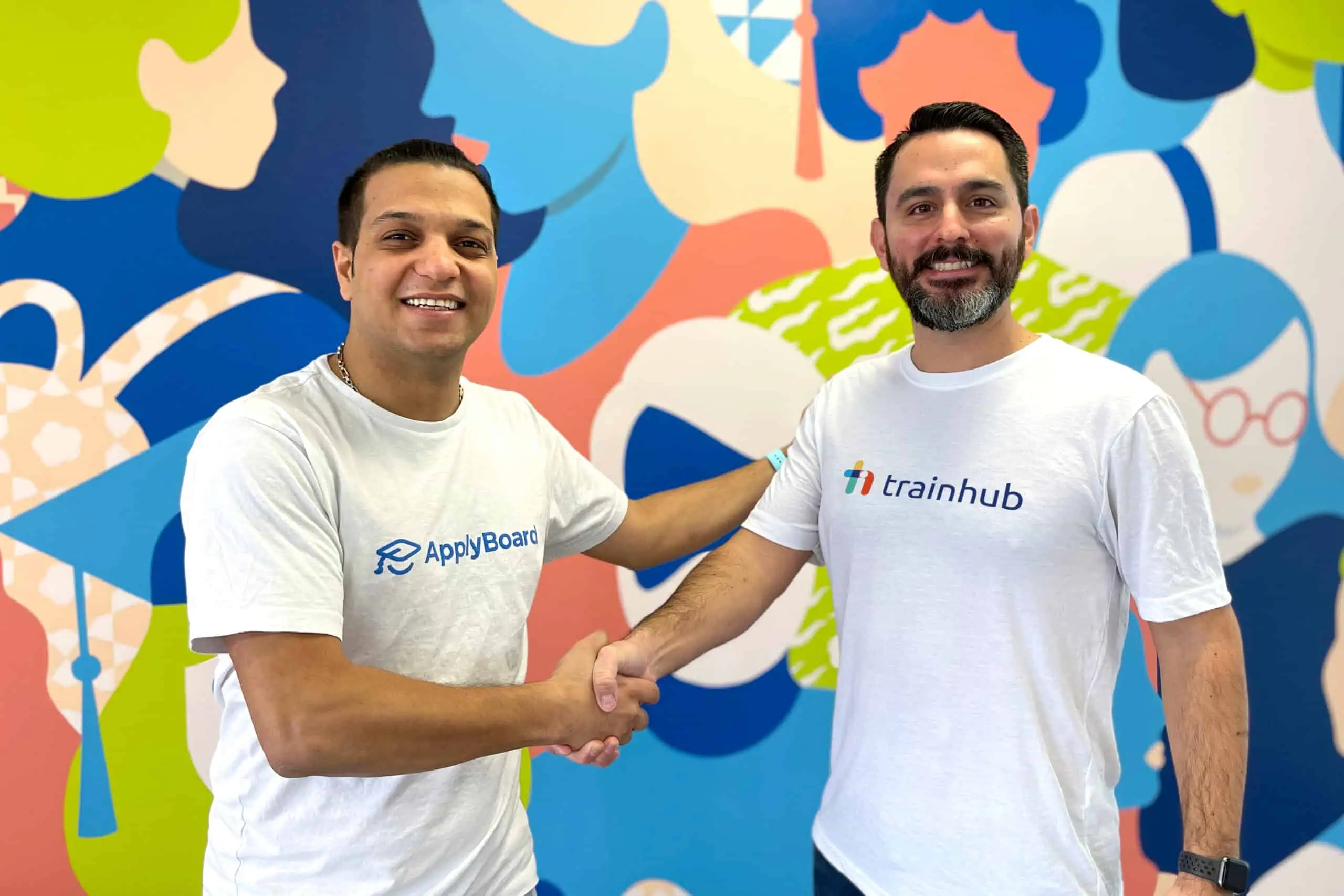 Meti Basiri and Jimmy Battaglia shaking hands to celebrate ApplyBoard acquiring TrainHub.