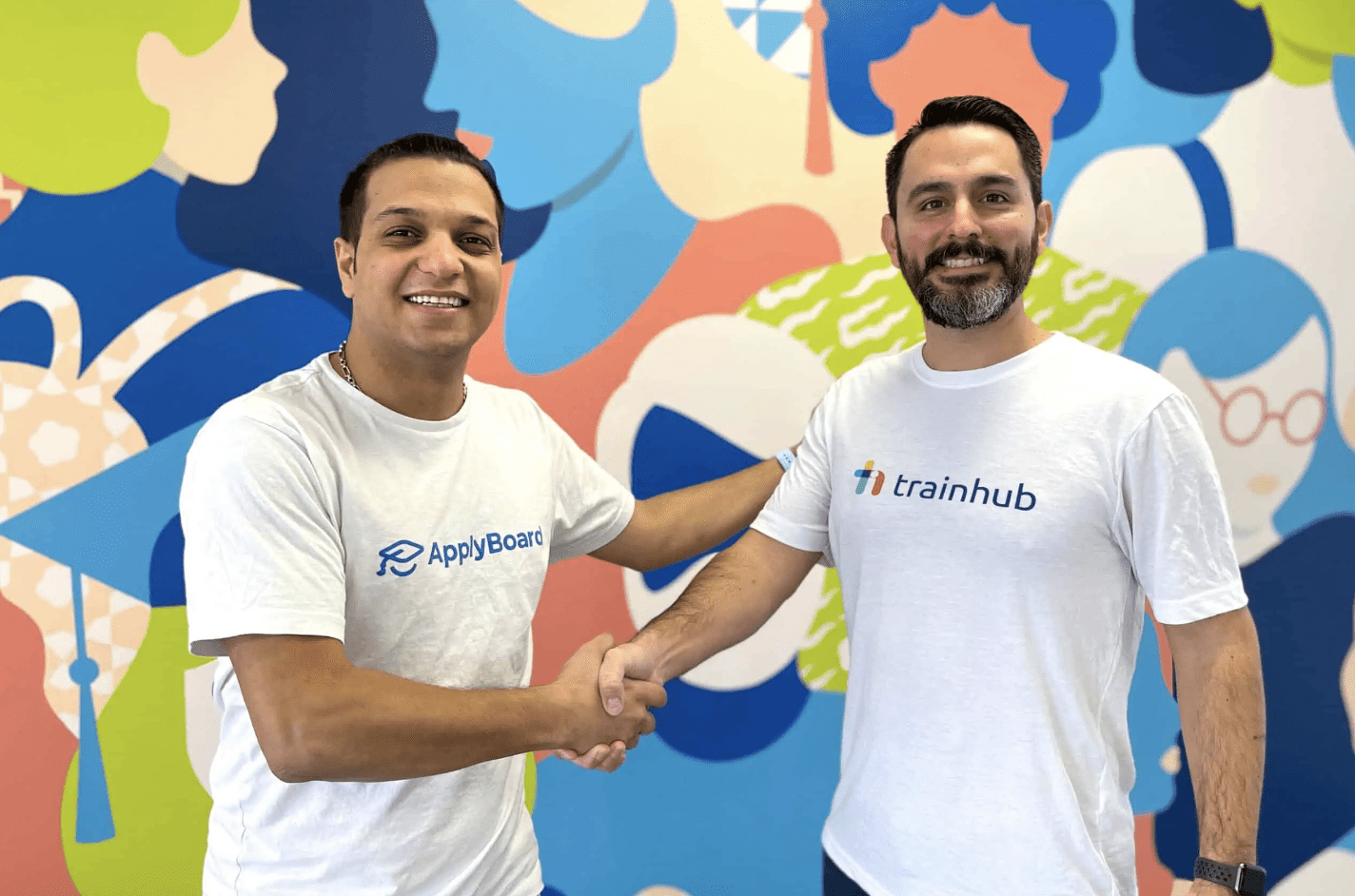 A photo of ApplyBoard Co-Founder, Meti Basiri, and Head of TrainHub, Jimmy Battaglia, shaking hands at ApplyBoard Canada HQ.