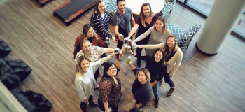 Members of Beer Club "cheers-ing" in the Kitchener ApplyBoard office